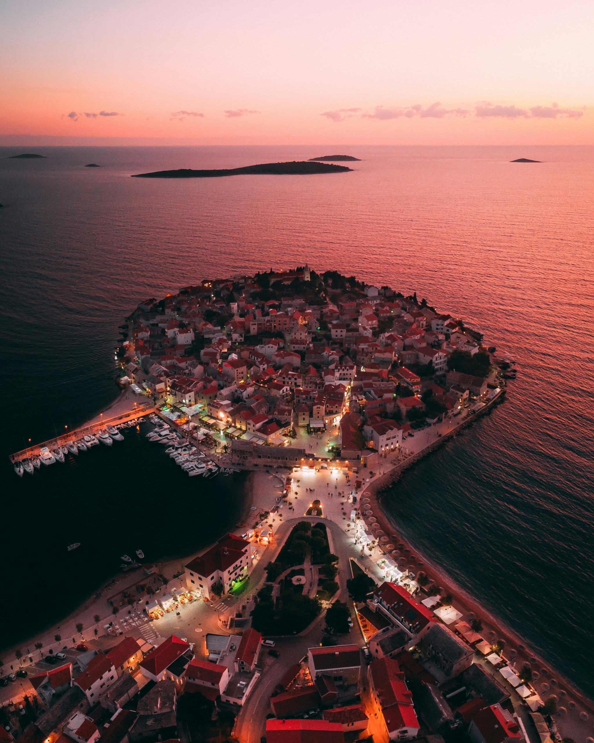 Primošten old town peninsula silhouetted against a Dalmatian sunset